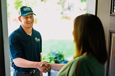 Apex Plumbing Technician Greeting Customer