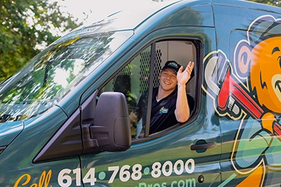 Apex Plumbing Technician Waving in Van