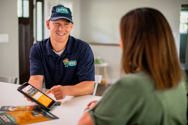 Worker showing customer the Alex cares program