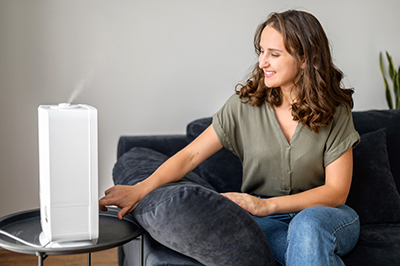 Woman turning on humidifier