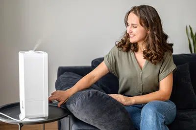 Woman turning on humidifier