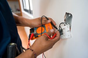 Close-up on an electrician repairing an electrical outlet